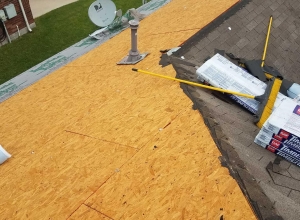 Shingles are stripped down to decking to ensure a proper replacement